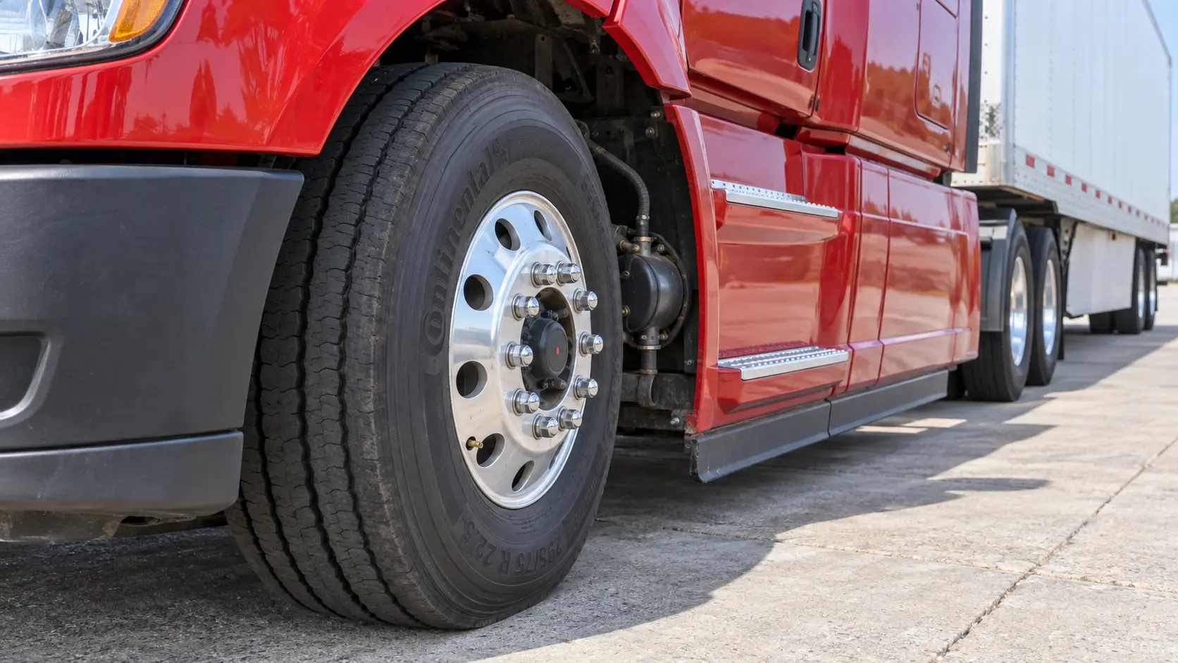 Mounted commercial-truck steer tire, wheel, hub, lug nuts and visible brake components inspected in normal road-ready configuration